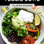 A healthy chipotle veggie bowl with roasted bell peppers.