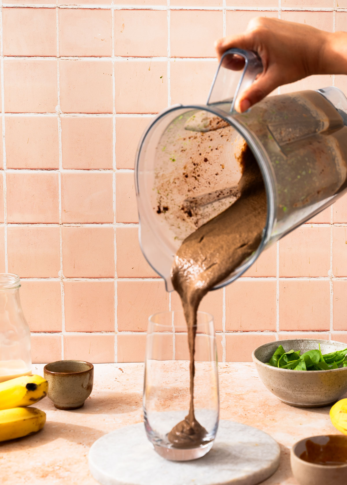 Fresh chocolate weight loss shake being poured.