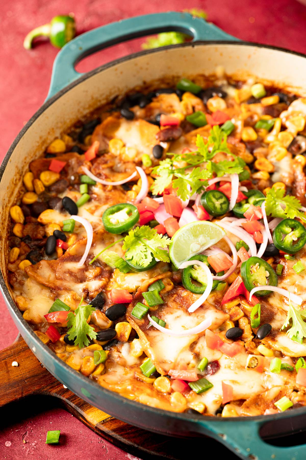 Vegan enchilada topped with vegan melted cheese and vegetables