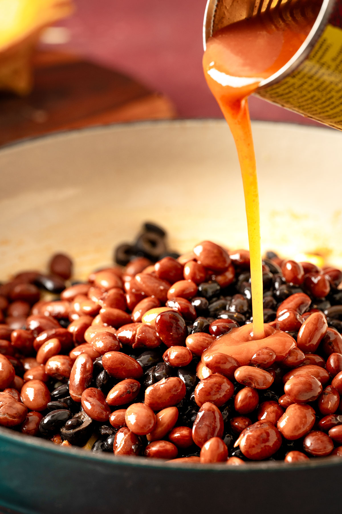 Rich red enchilada sauce added on top of the sautéed vegetables and beans mixture