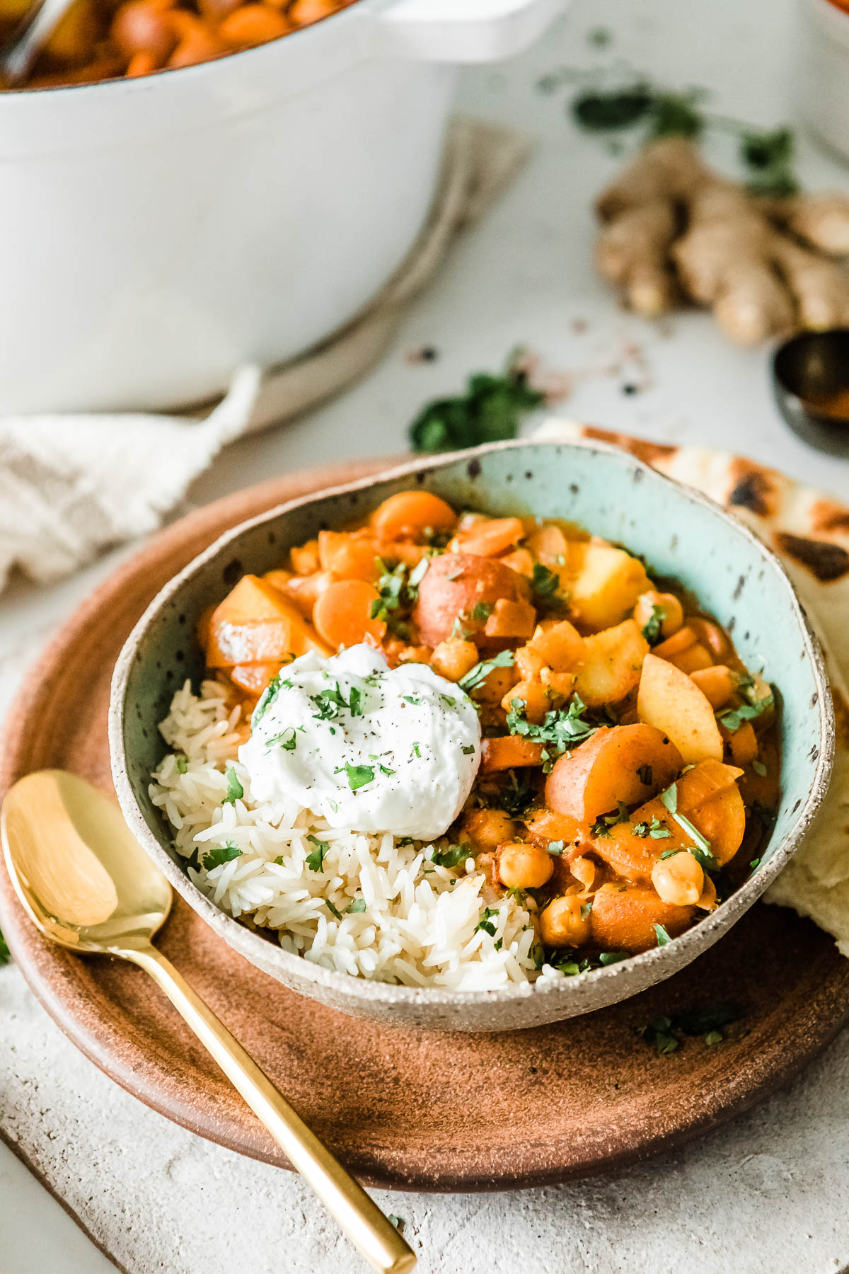 Creamy veggie curry in a bowl with rice and cashew cream.