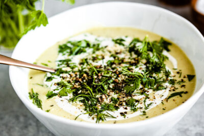 Creamy vegan celery soup in a bowl with a spoon