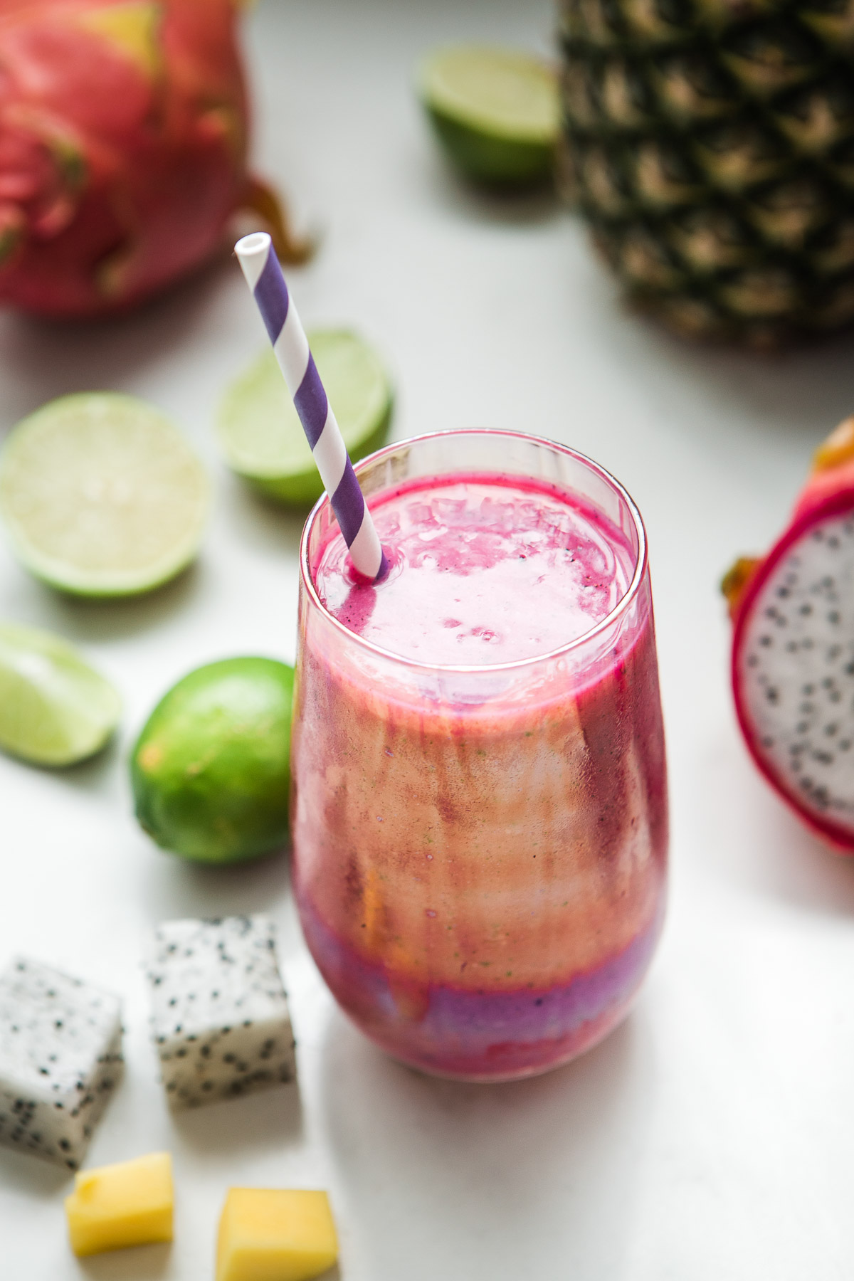 Deep pink dragon fruit smoothie in a glass.