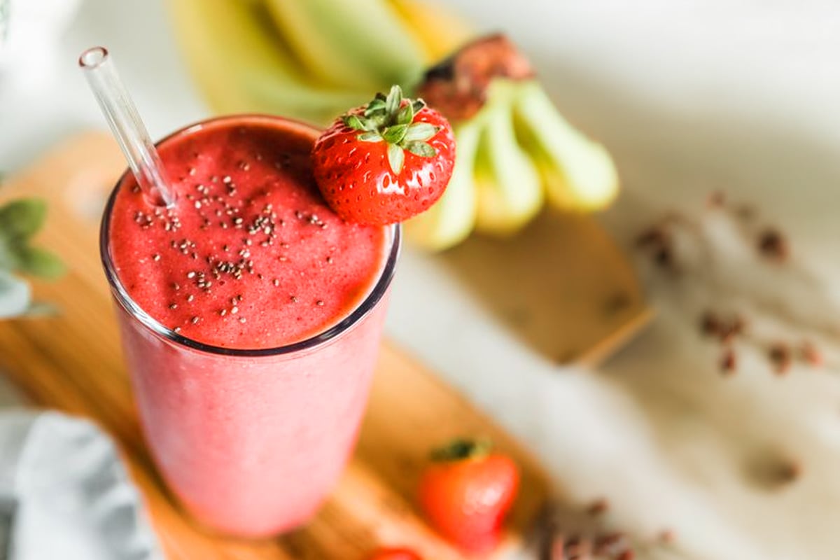 Easy strawberry smoothie garnished with a strawberry