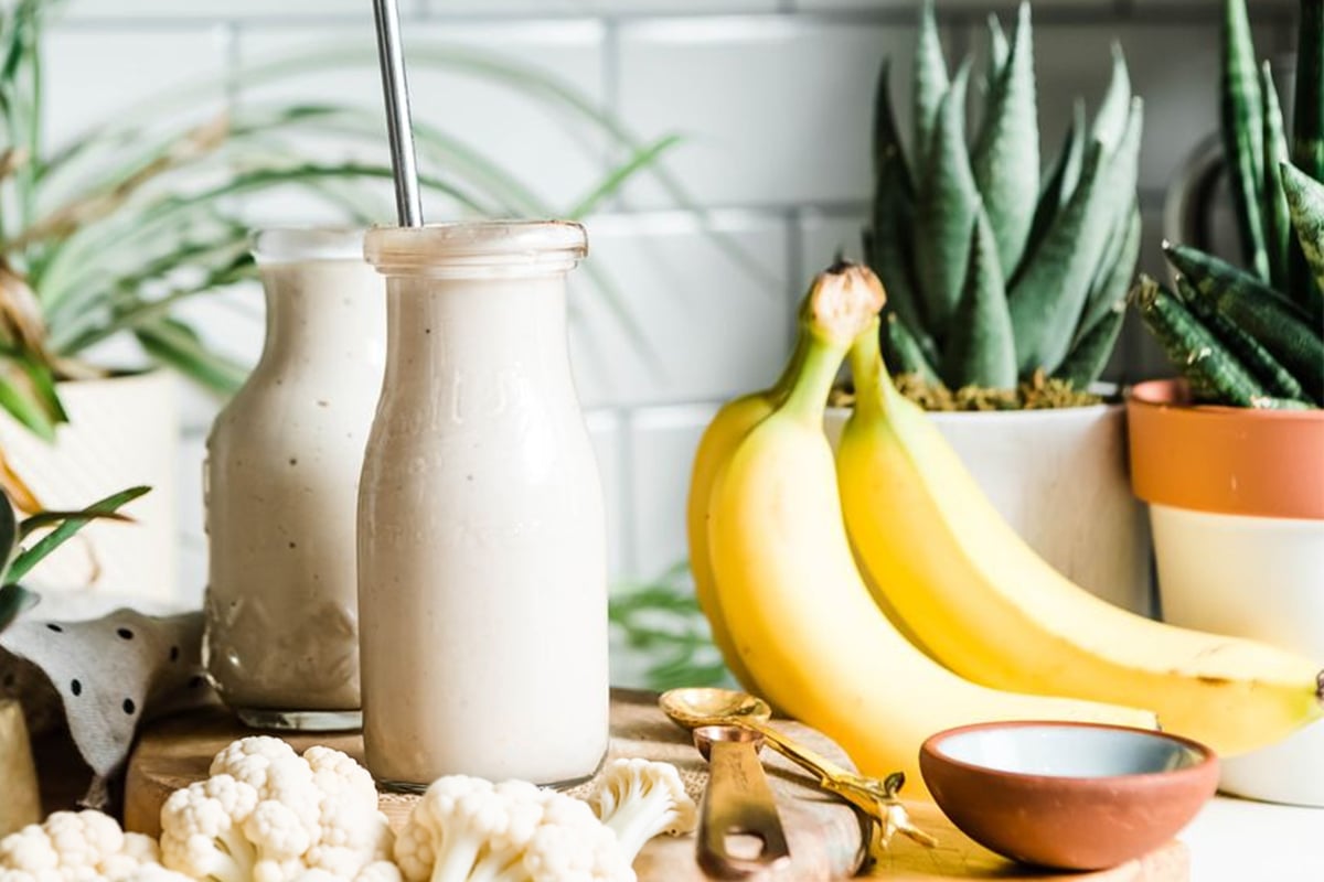 Easy banana smoothie surrounded by fresh ingredients