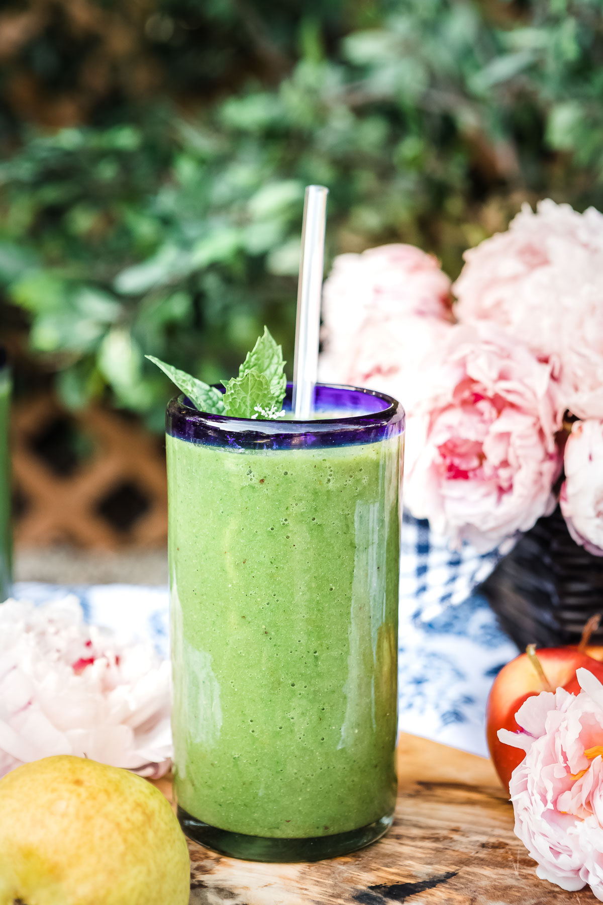 Fresh glowing green smoothie served in a clear glass
