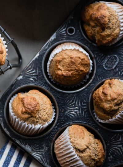 Gluten-free banana muffins in a muffin pan.
