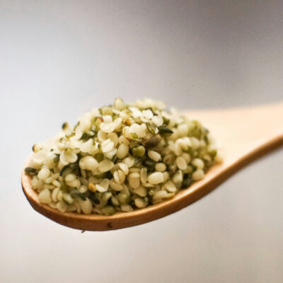 Close-up of a wooden spoon with hemp seeds.