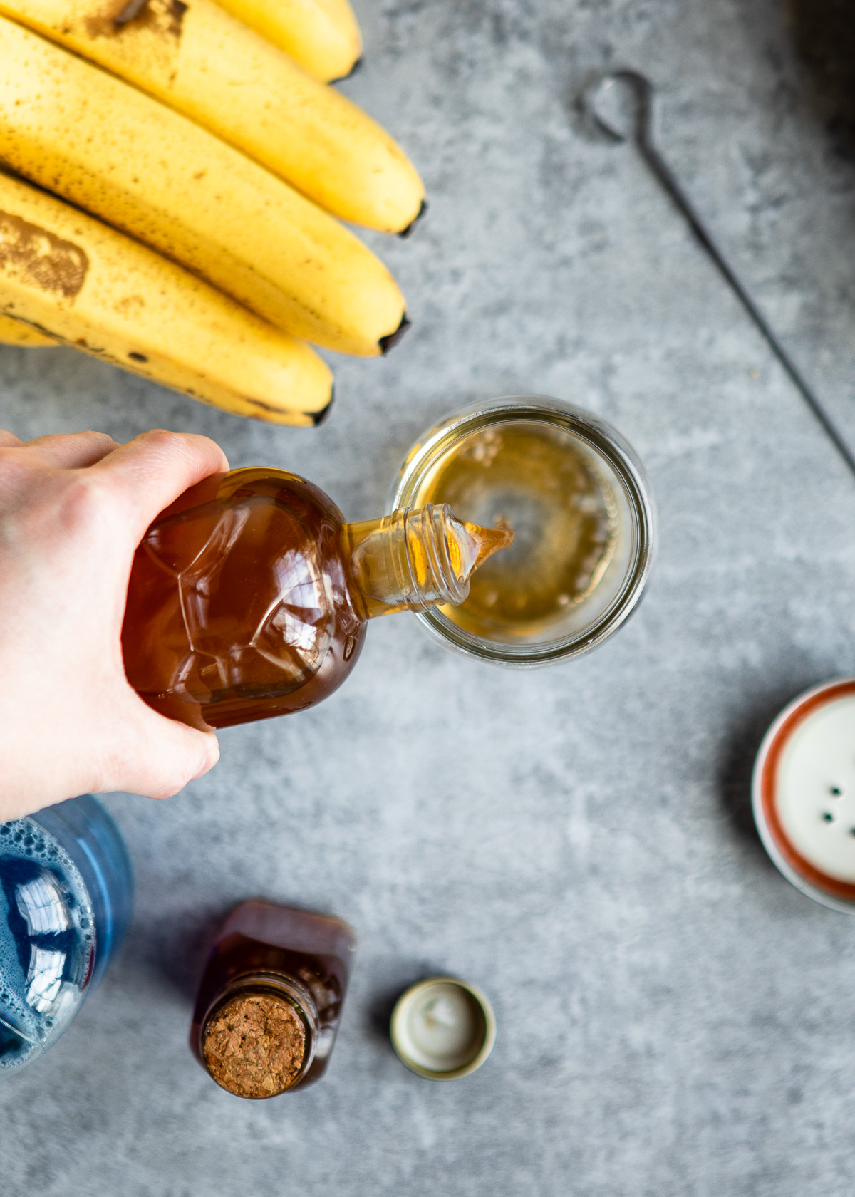 Mason jar being filled with apple cider vinegar.
