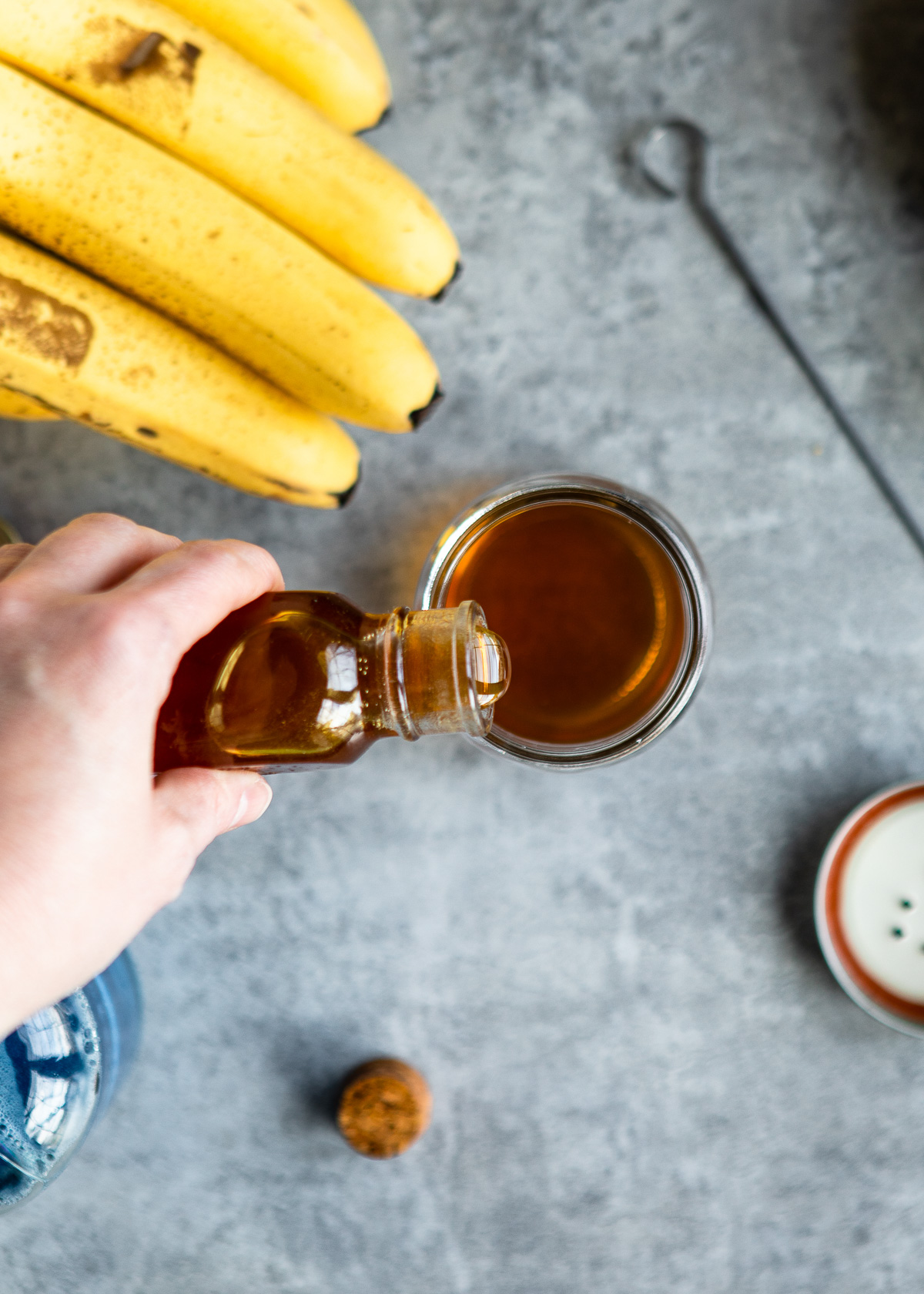 Adding honey into apple cider vinegar.
