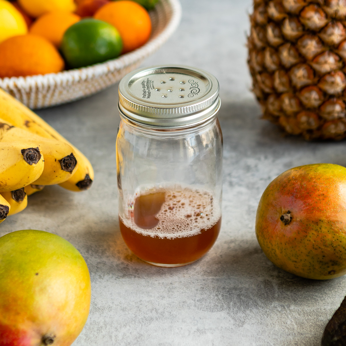 Mason jar filled with homemade fruit fly trap solution.