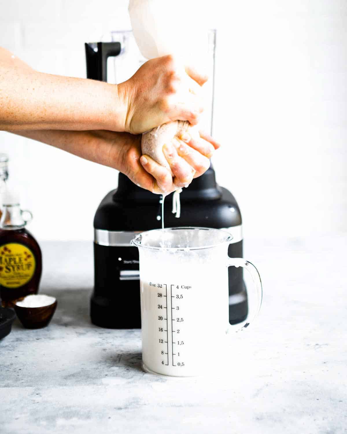 separating the liquid from the pulp of a cheesecloth into a measuring cup.