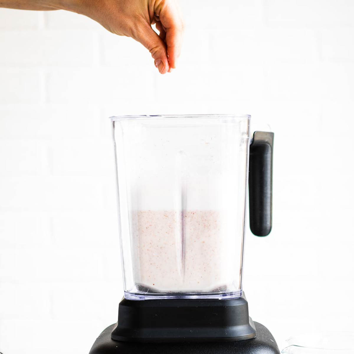 sprinkling salt into a blender container