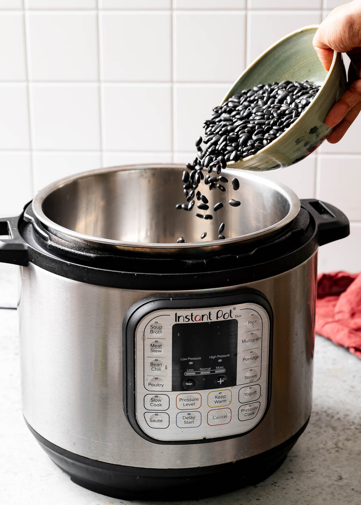 Black beans being poured into an instant pot