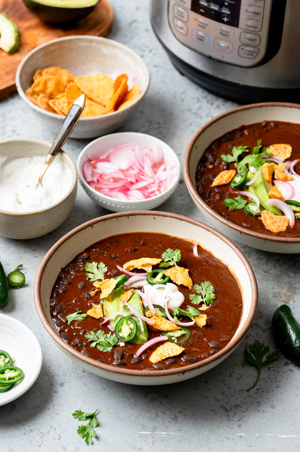 Freshly prepared instant pot black bean soup in bowls