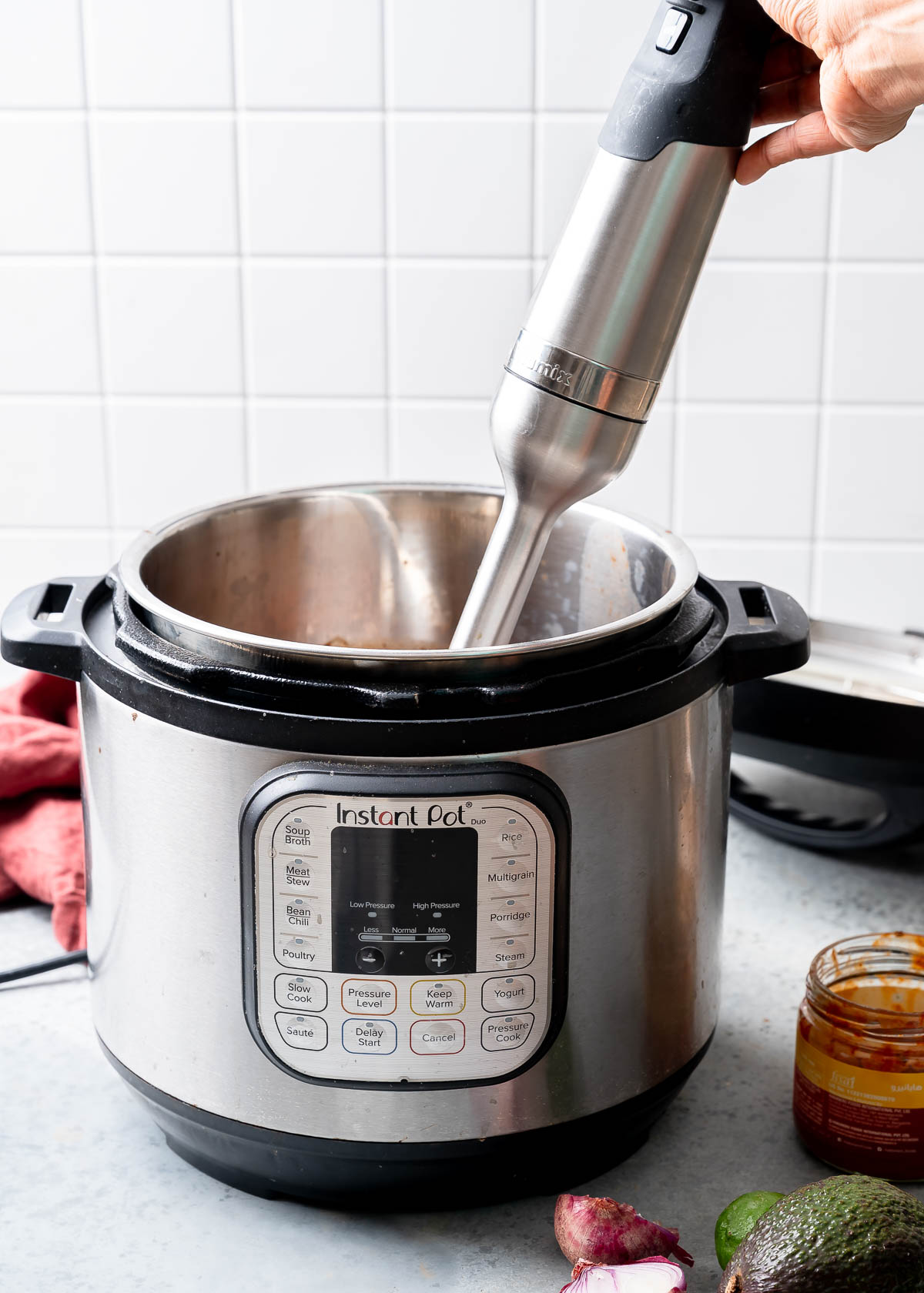 An immersion blender in an instant pot mixture