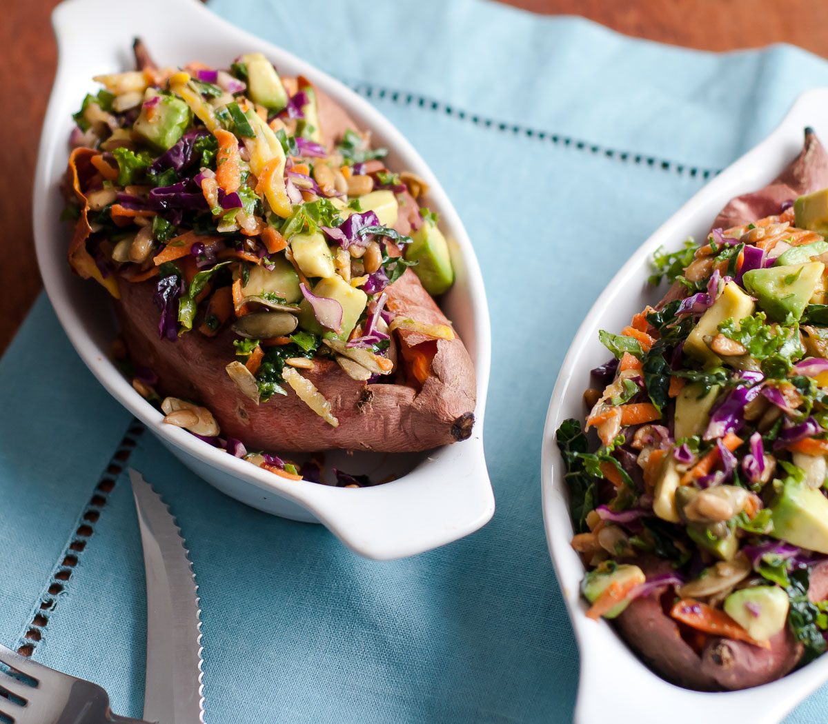 2 beautiful loaded sweet potatoes with kale slaw in fun gratin bowls, oven-baked to perfection.