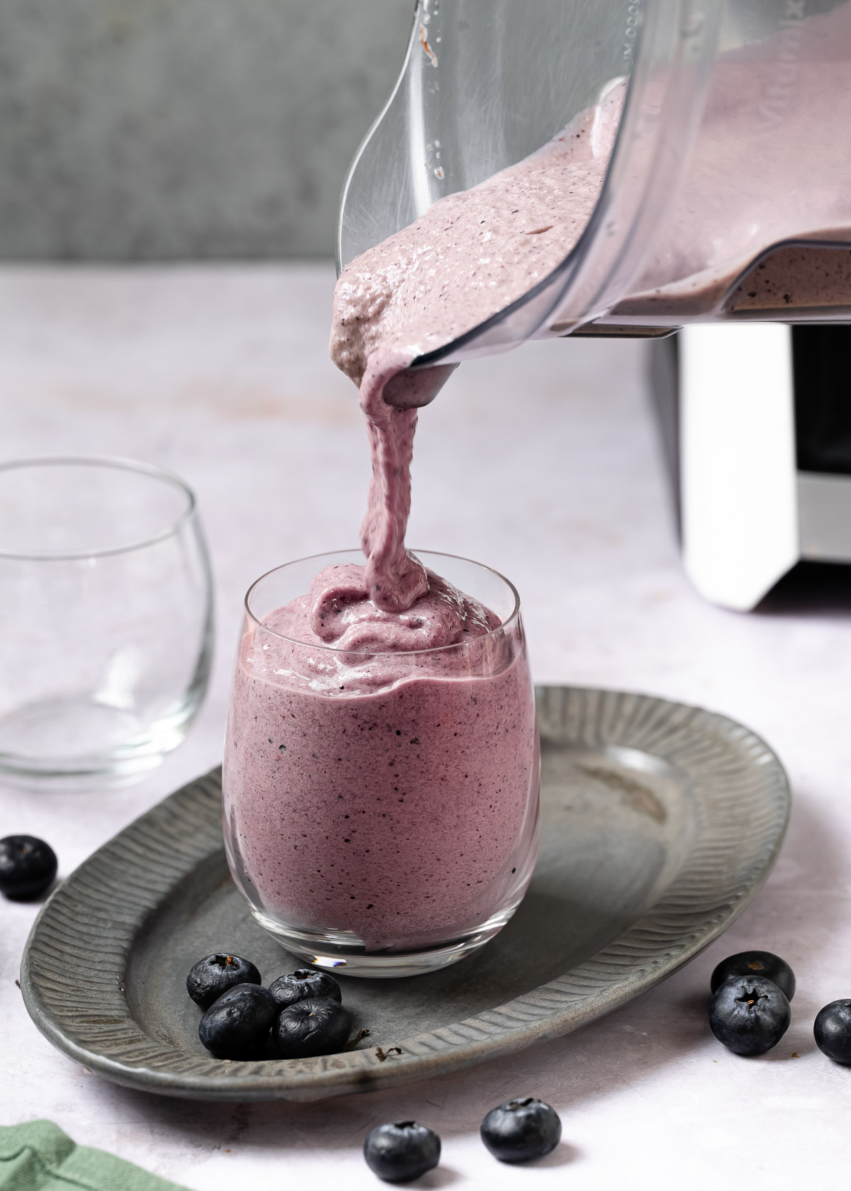 Pouring low-calorie protein shake in a glass