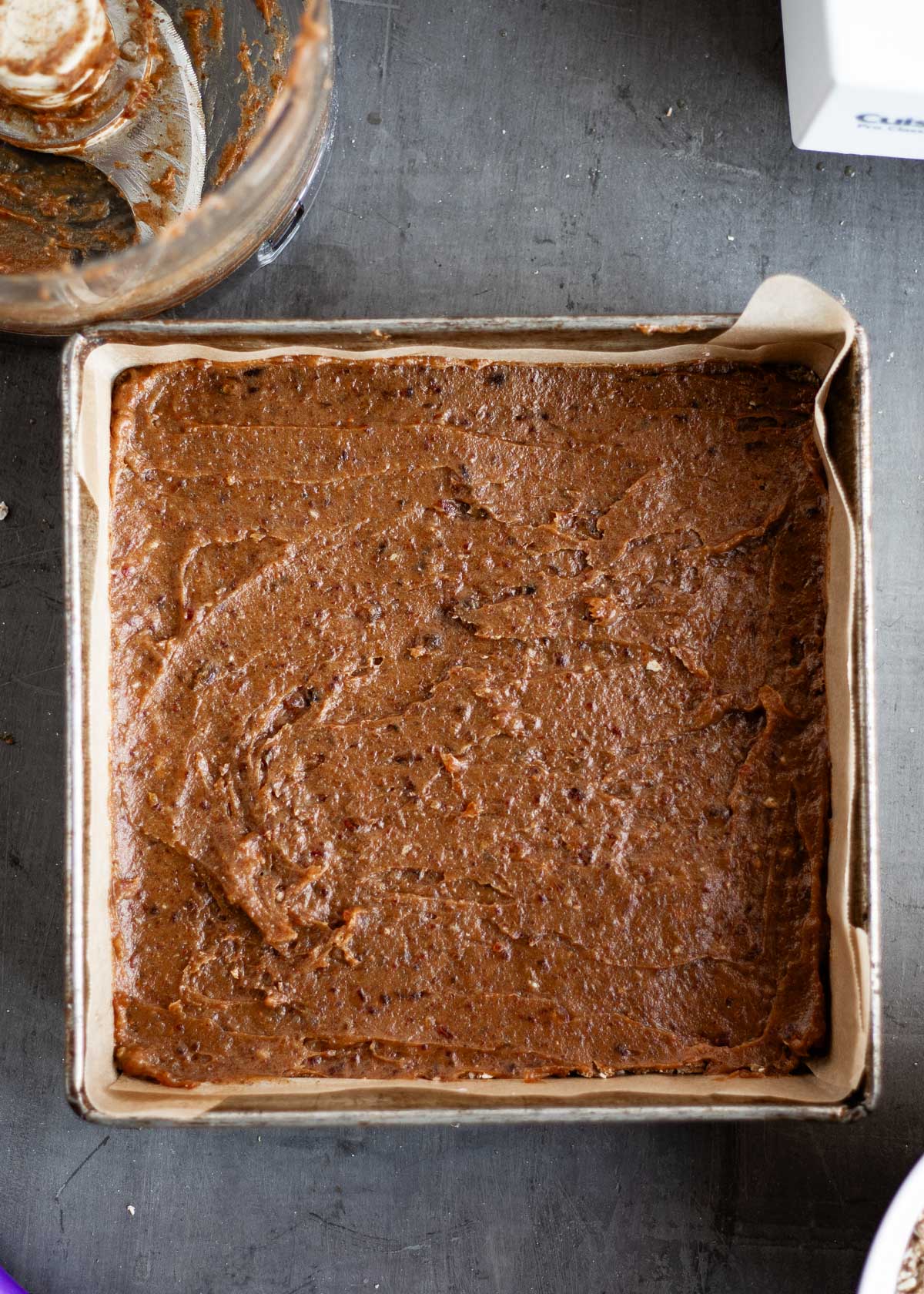 A date mixture spread out in a square baking dish