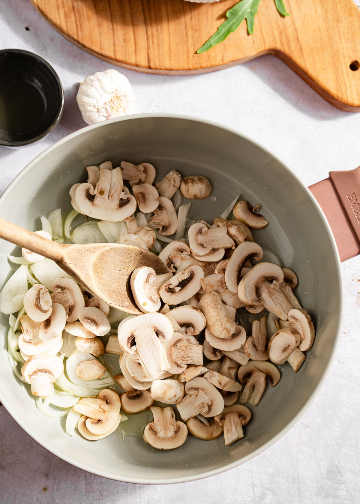 Sliced mushroom and onions in a pasta pot