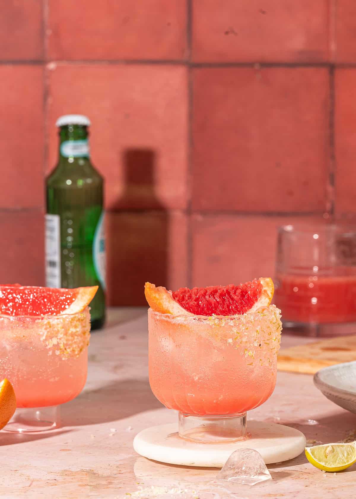 Refreshing paloma mocktail served over ice in a citrus-rimmed glass