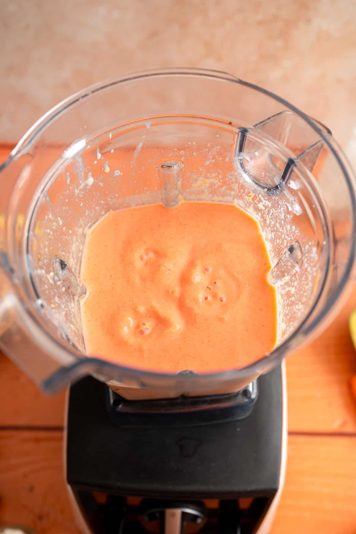 Blended papaya banana smoothie in a blender