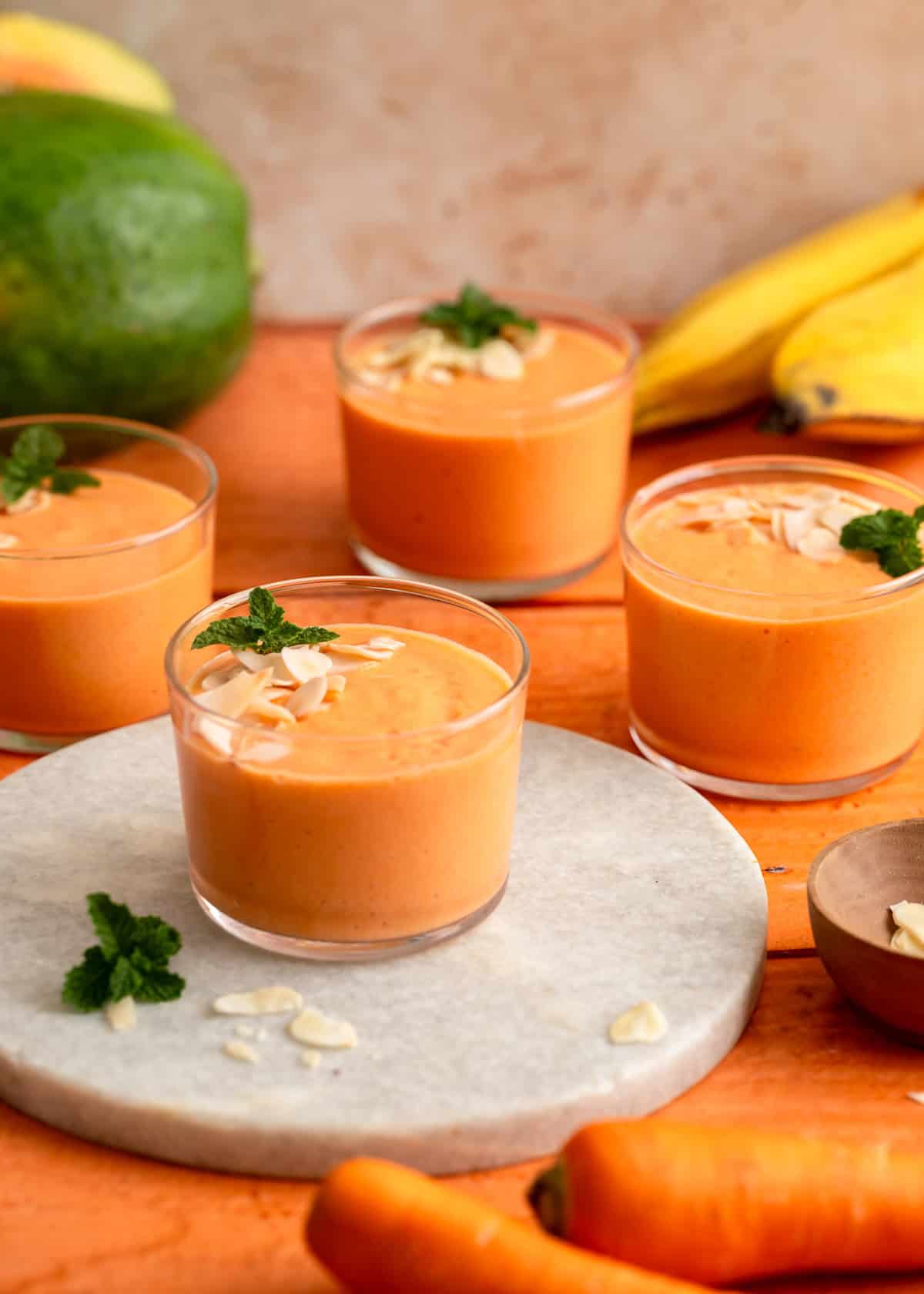 Healthy papaya banana smoothie in glasses ready to sip