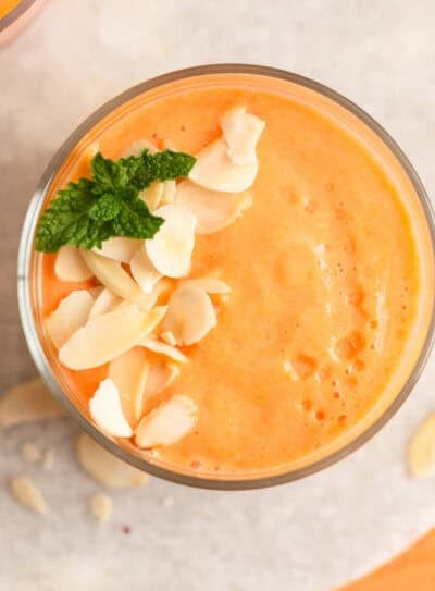 Creamy papaya banana smoothie with mint garnish