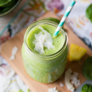 Overhead view of a Piña Colada smoothie garnished with coconut flakes.