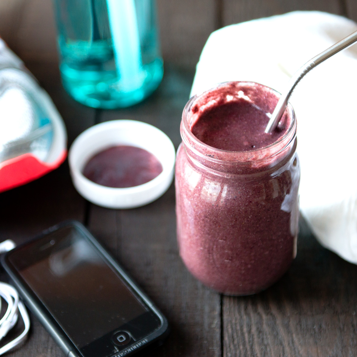 post workout smoothie with water bottle and running shoes.