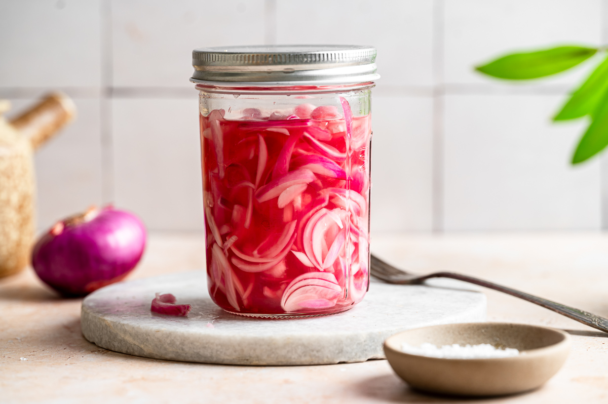A closed jar of quick pickled red onions