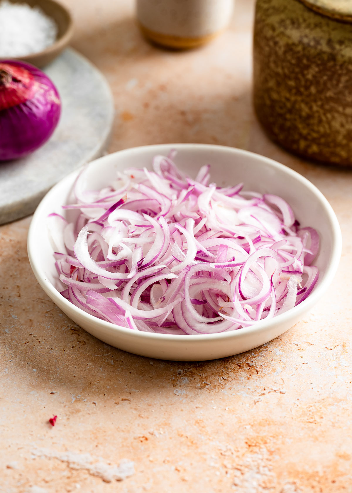 A plate of thinly sliced red onion