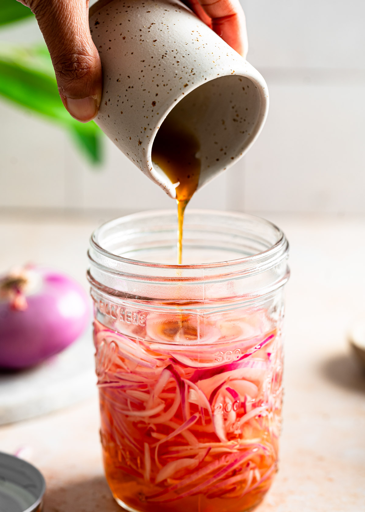 Pouring maple syrup in an onion mixture