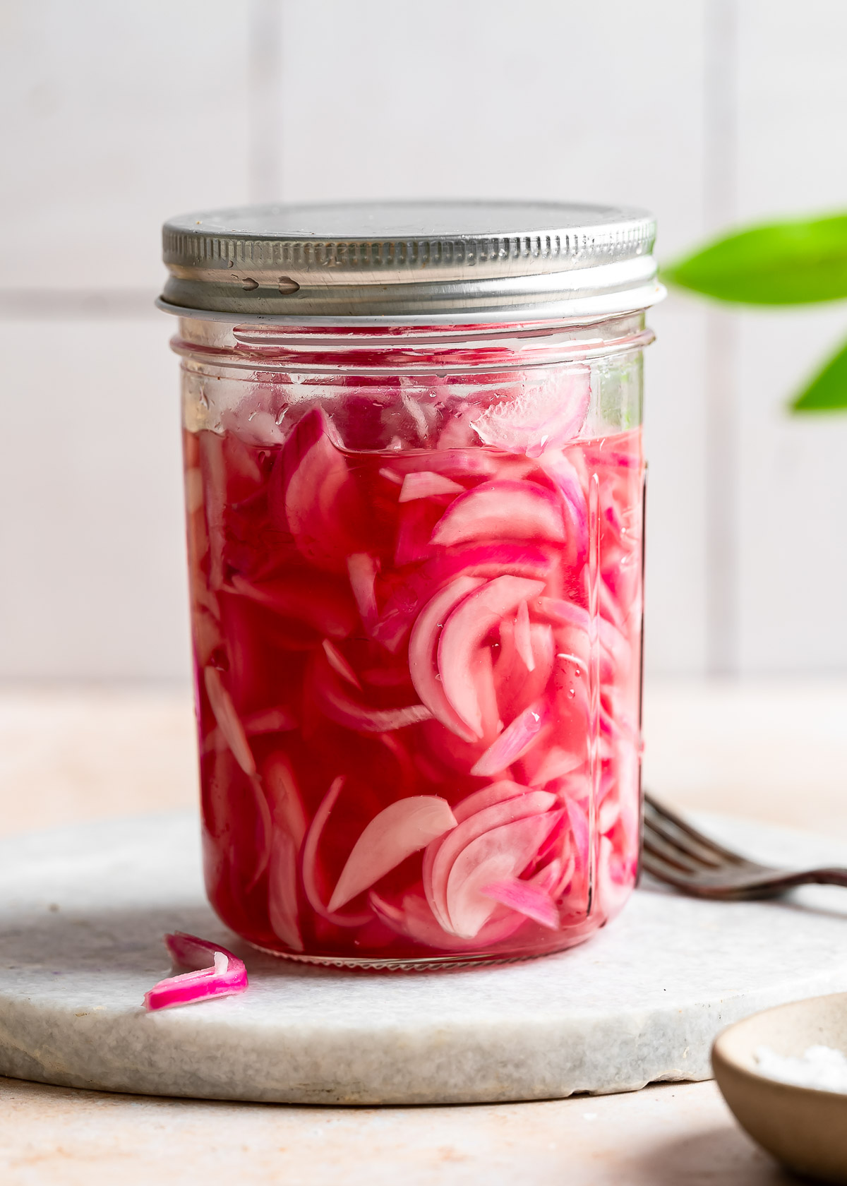 A closed jar of pickled red onions 