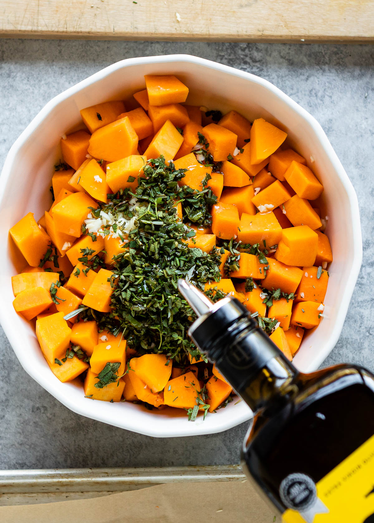 Adding avocado oil over butternut squash