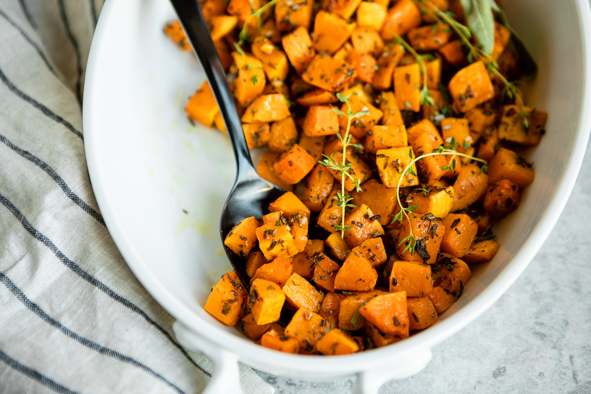 Freshly roasted butternut squash cubes in a serving dish
