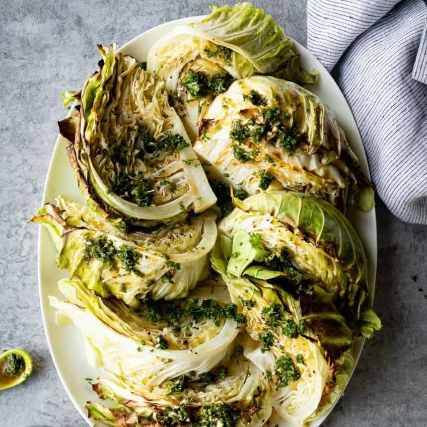 Oblong plate of roasted cabbage wedges.