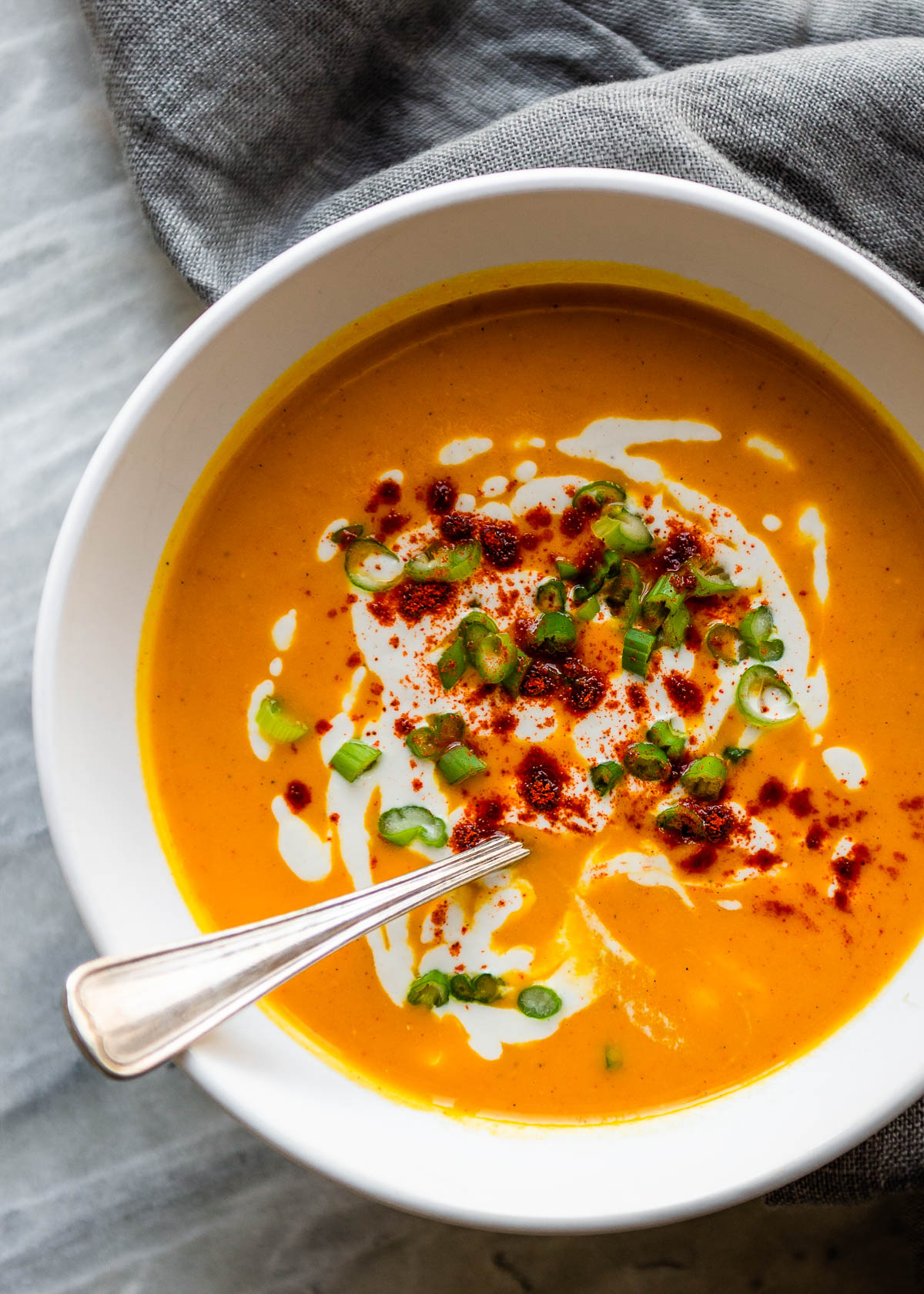 Red pepper soup garnished with cayenne and green chili