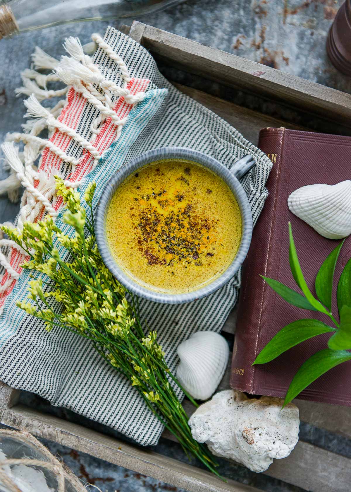 A cup of golden milk with cinnamon powder topping