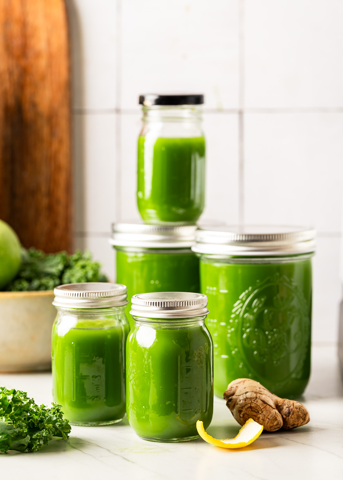 Freshly blended green juice stored in lidded mason jars