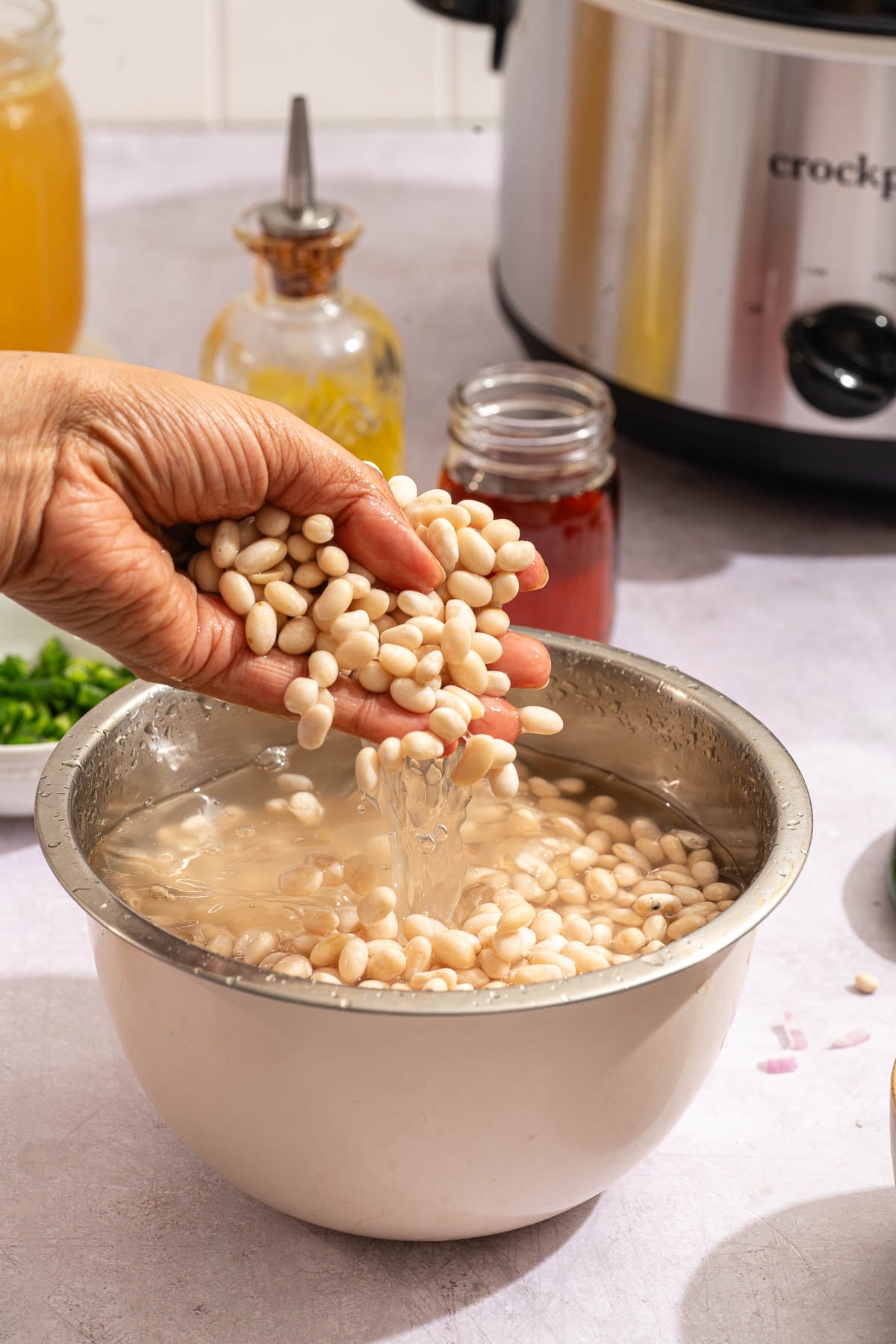 Navy beans soaking in a bowl of water