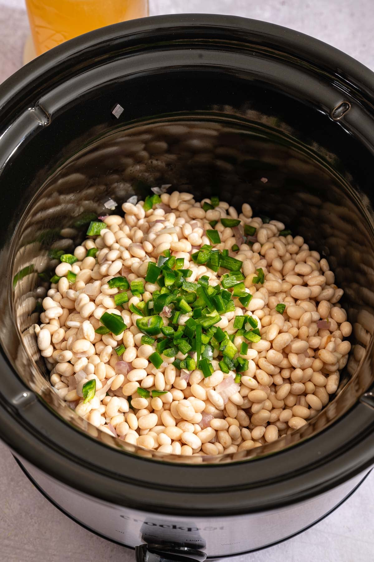 Soaked navy beans, sautéed veggies, and jalapeños in a slow cooker