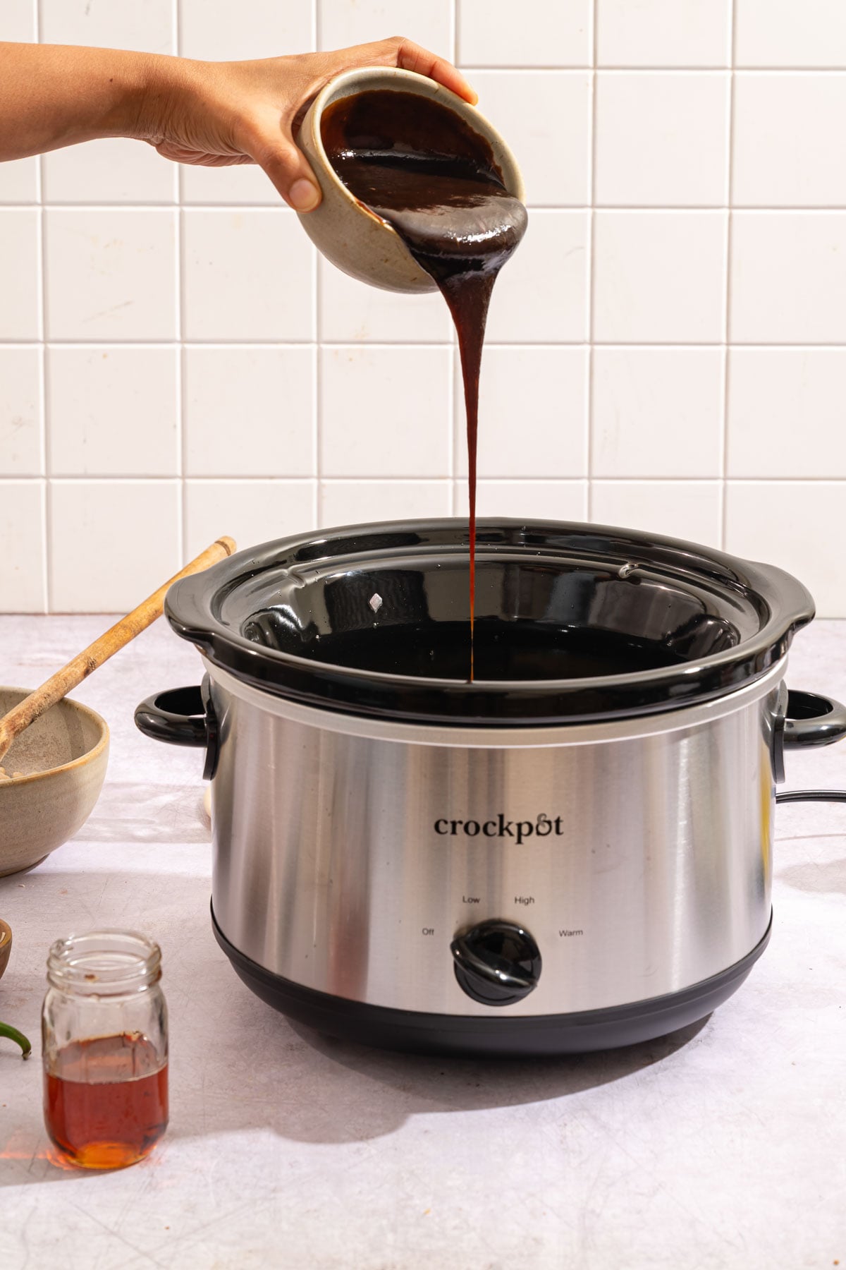 Pouring molasses in the slow cooker