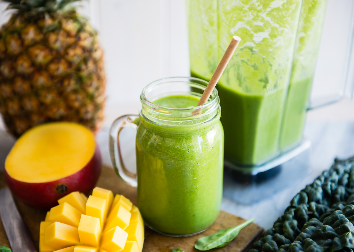 Detox smoothie in a mason jar with a paper straw