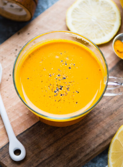 A glass mug brimming with golden turmeric tea, inviting to be savored.