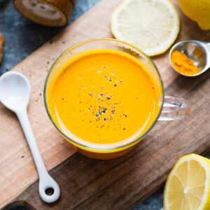 A glass mug brimming with golden turmeric tea, inviting to be savored.