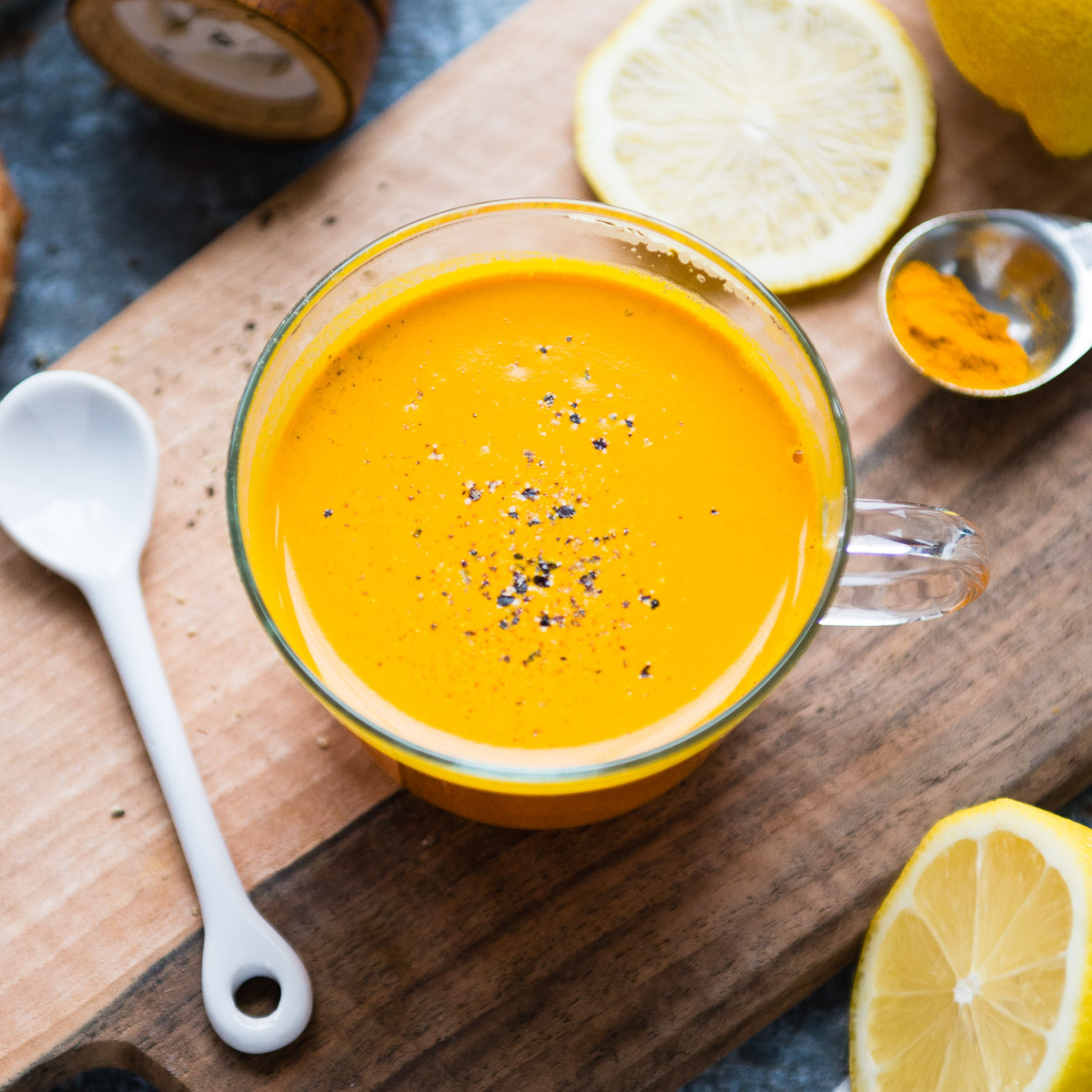 A glass mug brimming with golden turmeric tea, inviting to be savored.