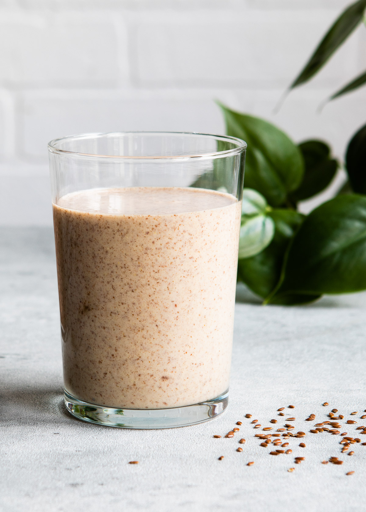 Single serving of flaxseed smoothie in a glass on a table