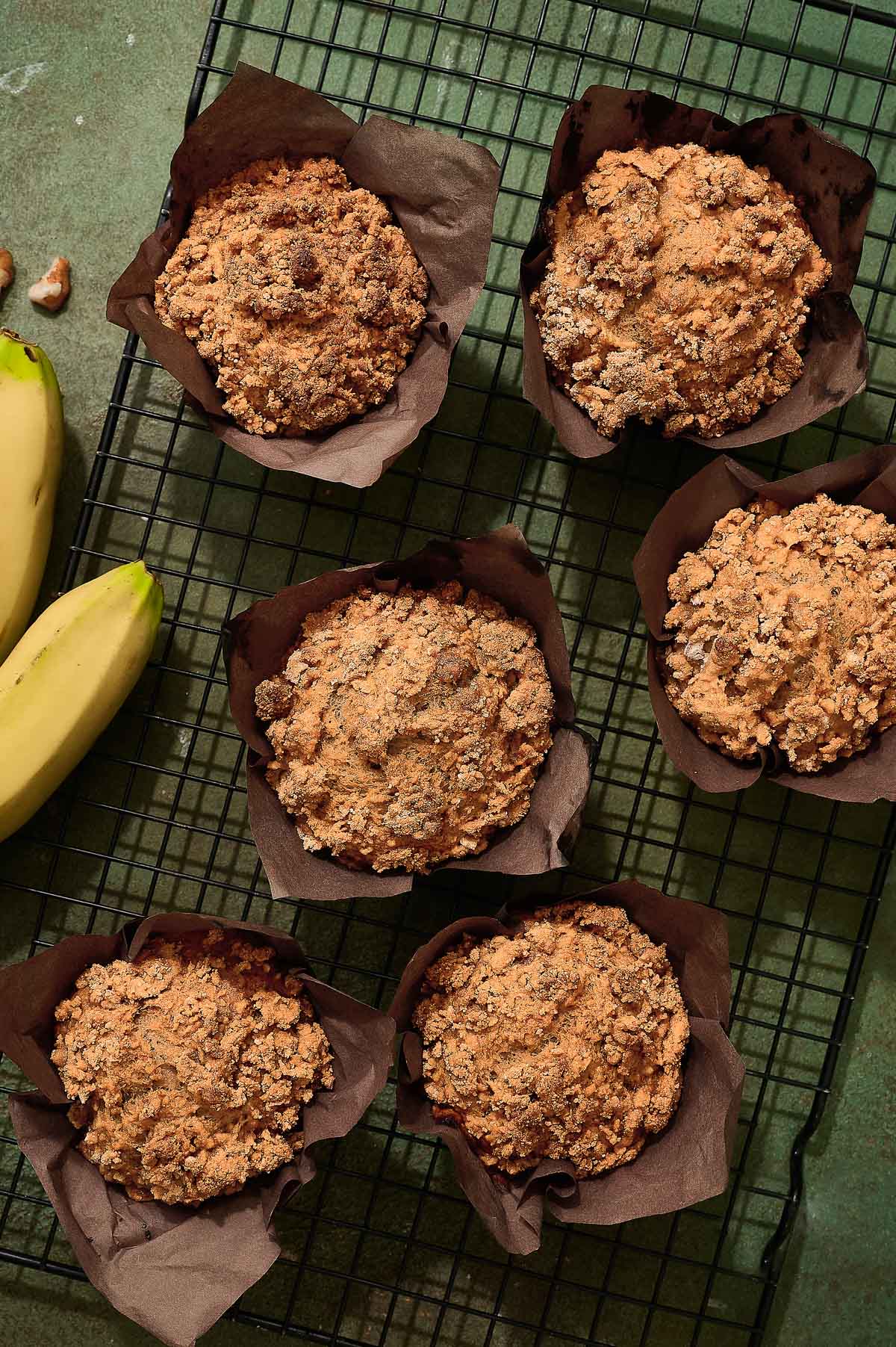 Freshly baked vegan banana muffins cooling on a wire rack