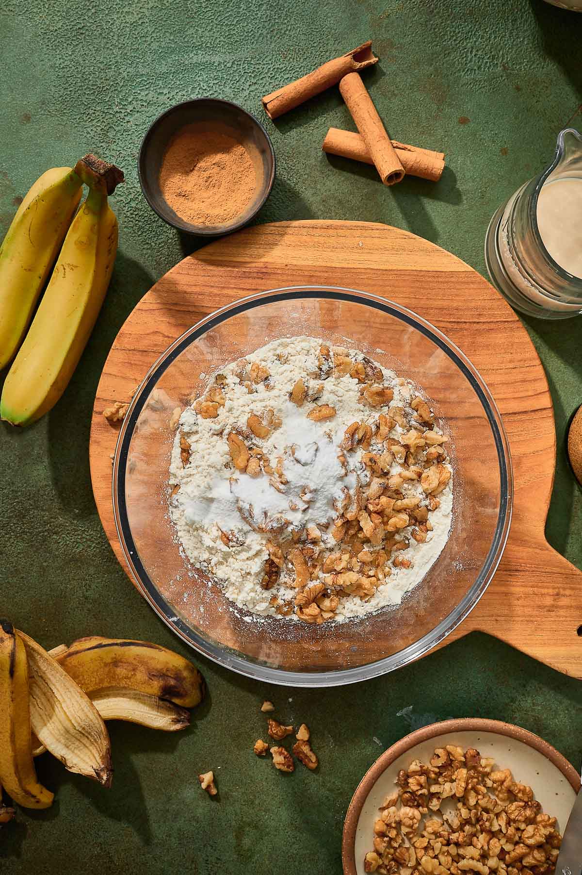 Mixture of flour, baking soda, and walnuts in a bowl